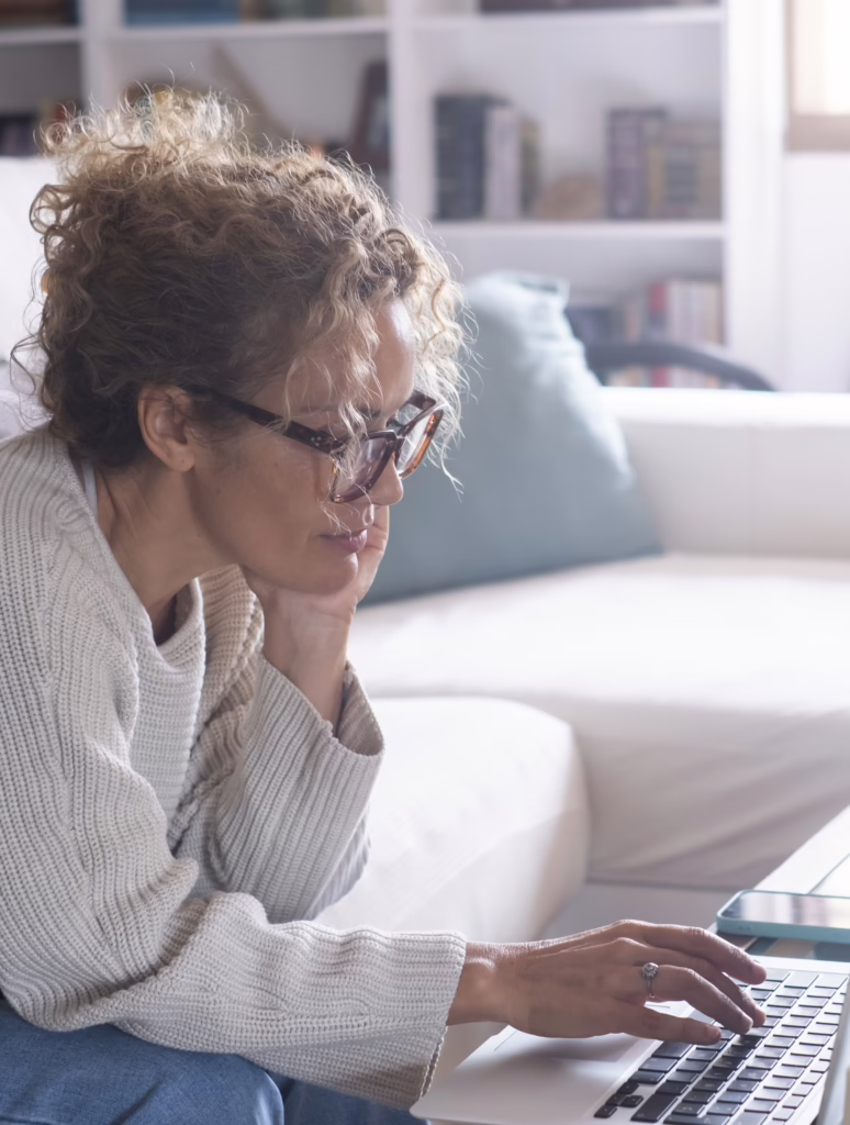 Relax, typing and woman on a couch, laptop and search website at